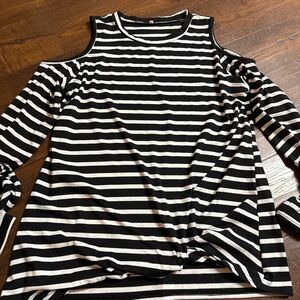 A black and white striped cold-shoulder top with long sleeves